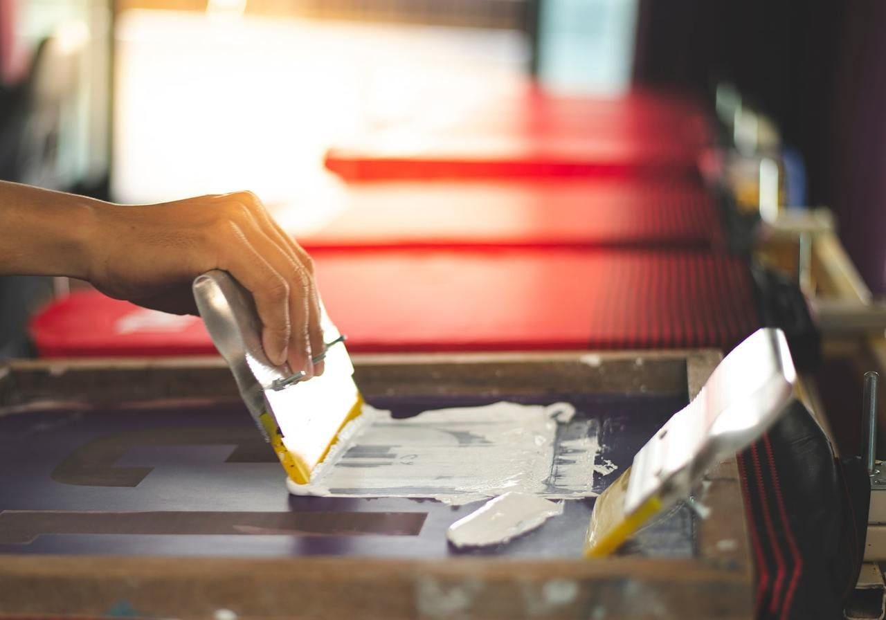 The process of screen printing on a t-shirt.